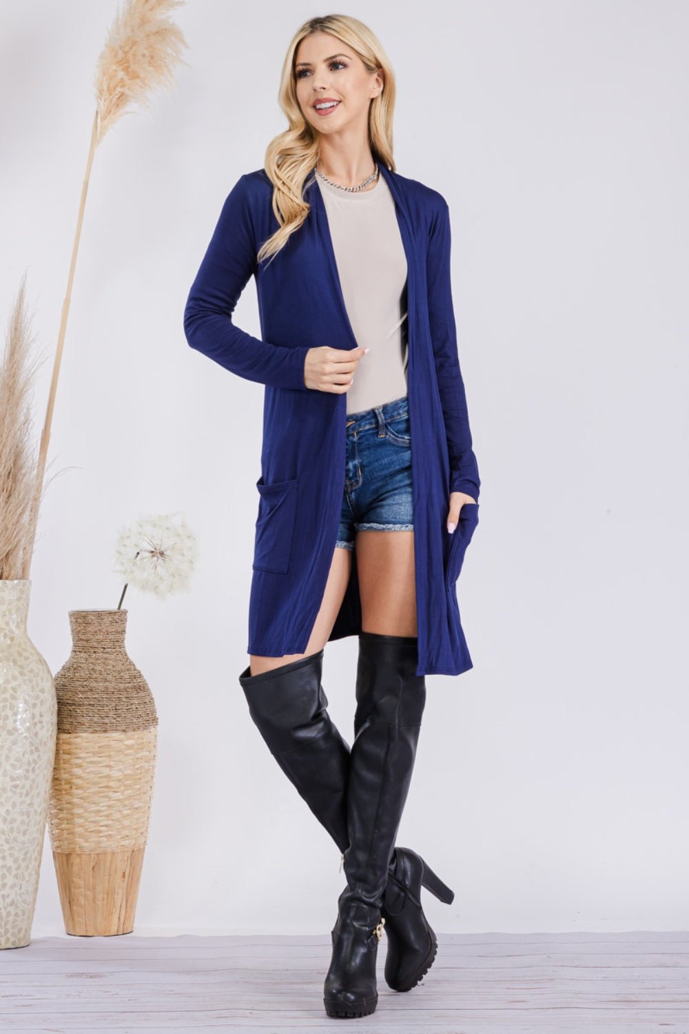 Celeste Full Size Open Front Cardigan in a soft fabric featuring two front pockets and a relaxed fit displayed on a neutral background.