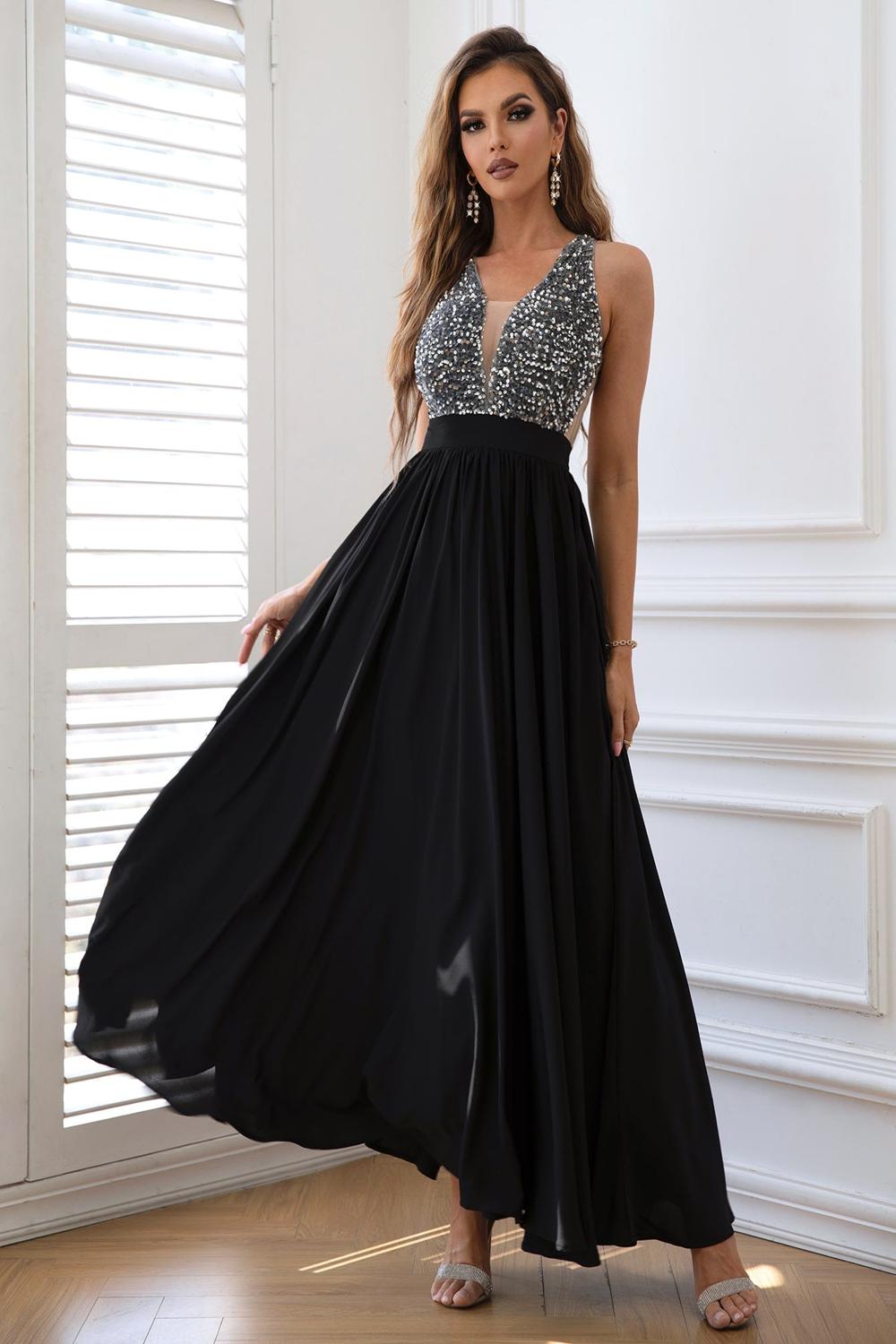  A stylish contrast sequin sleeveless maxi dress featuring a shimmering bodice with black and silver sequins flowing into a soft solid black skirt.