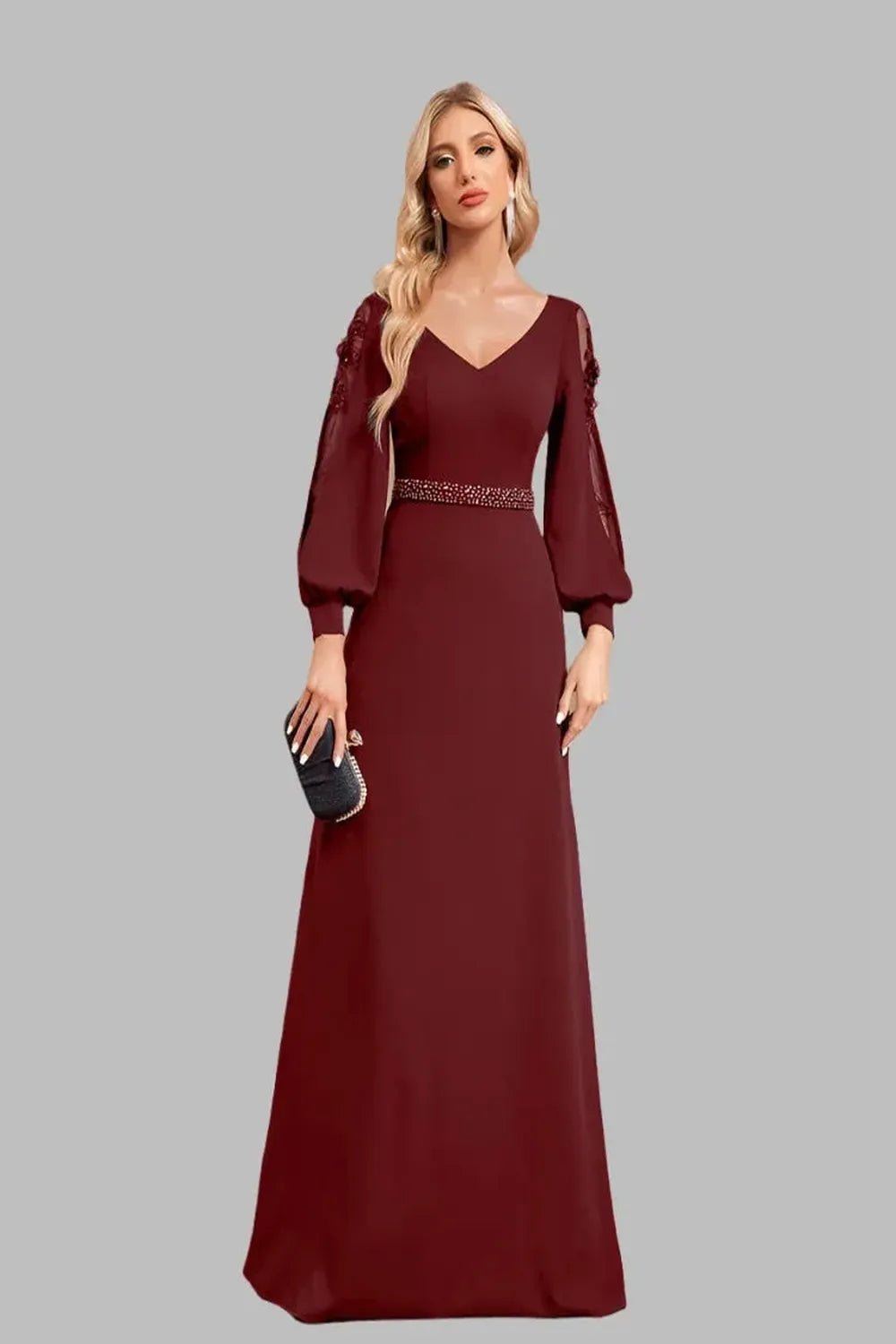 Elegant floorlength dress with long sleeves and a Vneck design featuring a flowing silhouette and sophisticated fabric.