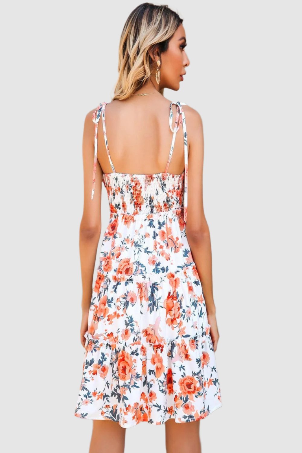  Floral tiered spaghetti strap dress featuring a vibrant floral pattern delicate straps and a flowing silhouette ideal for summer wear.