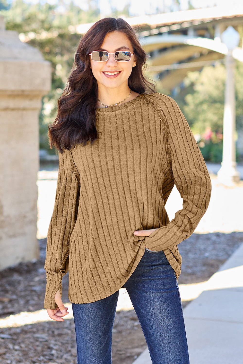 Full size ribbed round neck long sleeve knit top in a soft stretchy fabric featuring a fitted silhouette and subtle texture displayed on a neutral background.