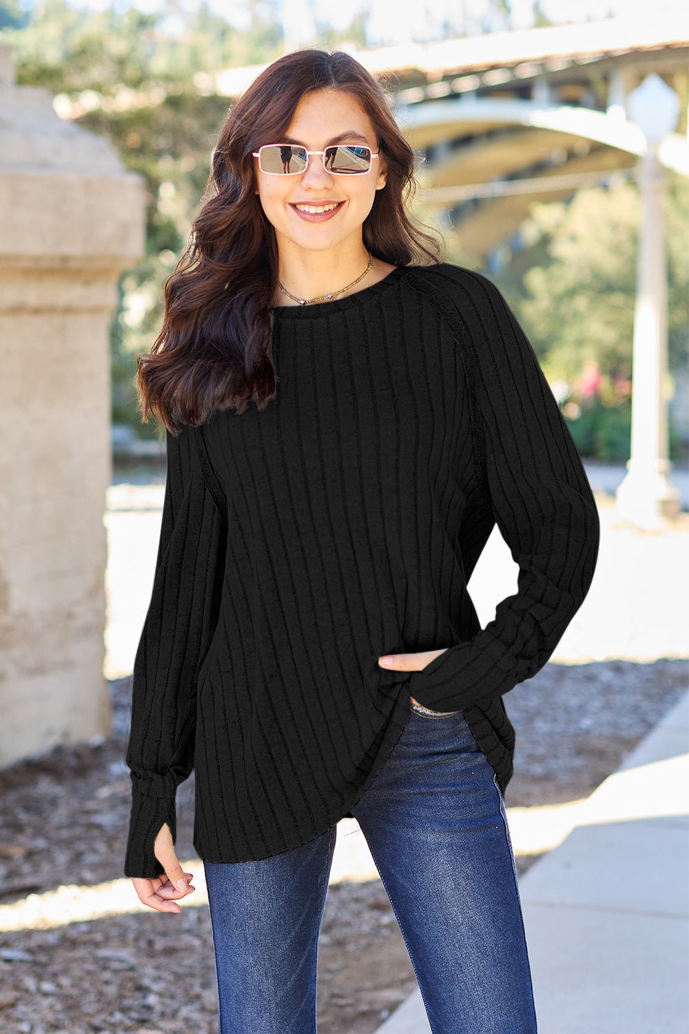 Full size ribbed round neck long sleeve knit top in a soft stretchy fabric featuring a fitted silhouette and subtle texture displayed on a neutral background.