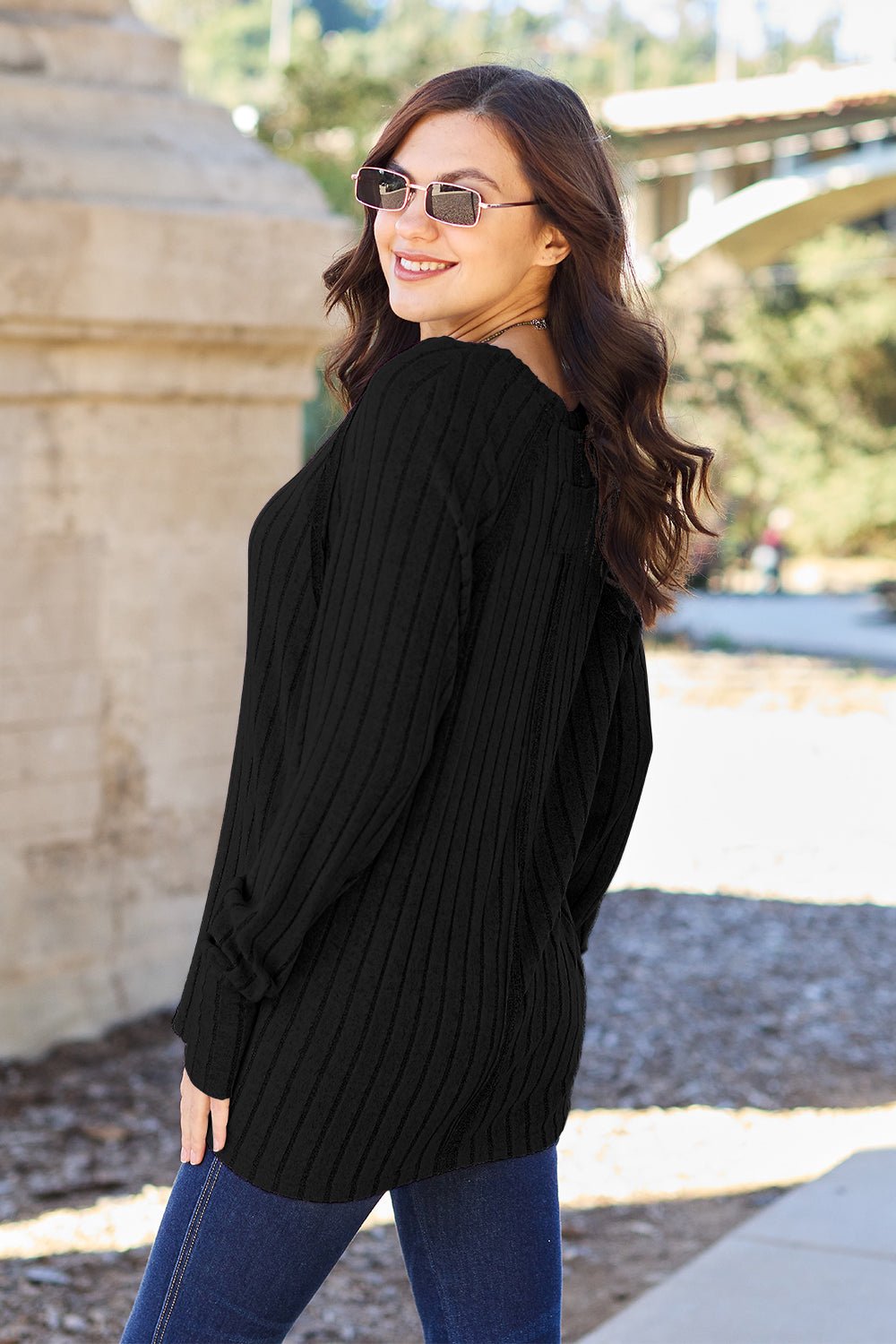 Full size ribbed round neck long sleeve knit top in a soft stretchy fabric featuring a fitted silhouette and subtle texture displayed on a neutral background.