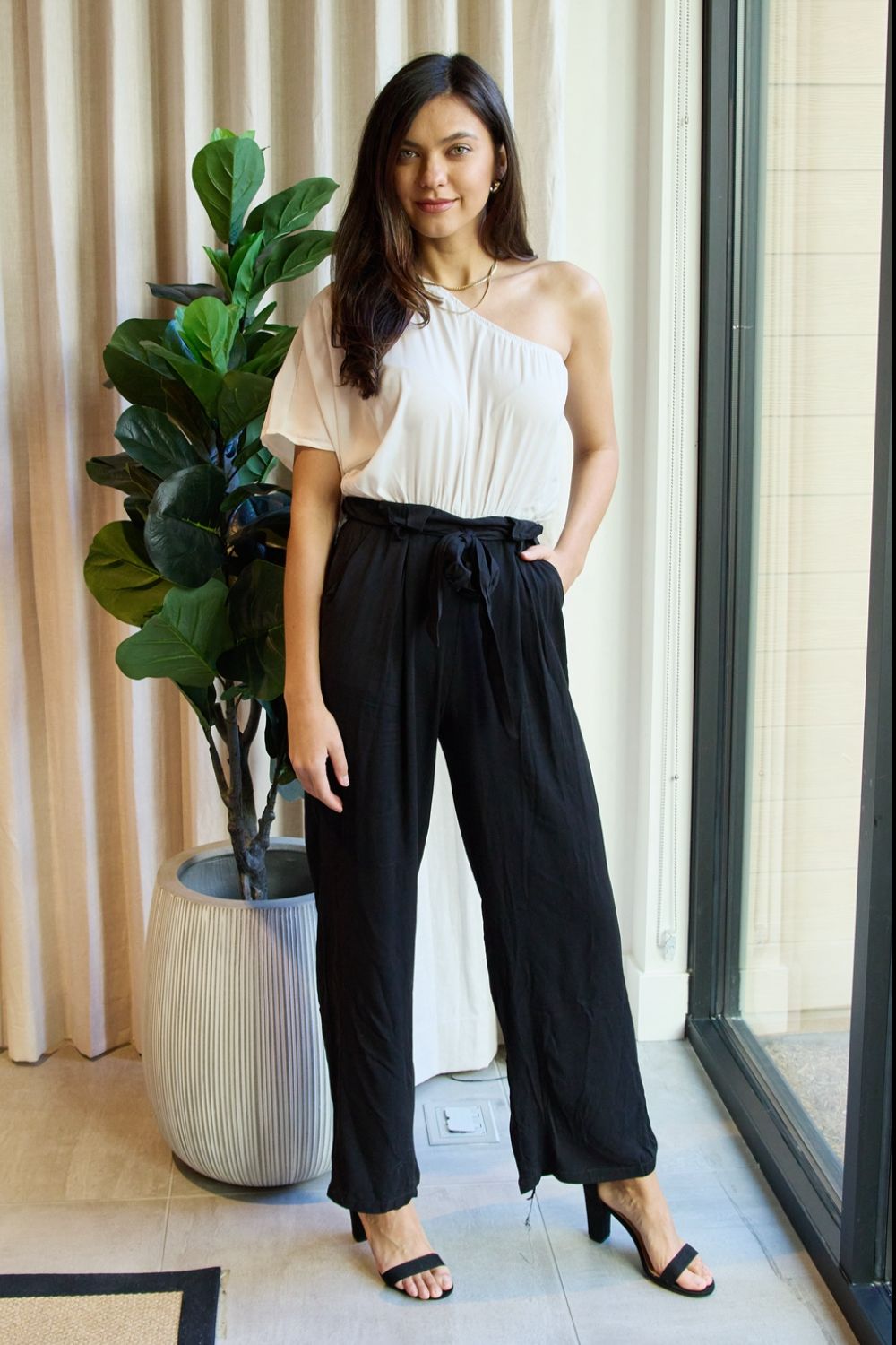 Manhattan One-Shoulder Jumpsuit in White/Black, featuring a chic one-shoulder design and a sleek monochrome color scheme, perfect for a sophisticated look.