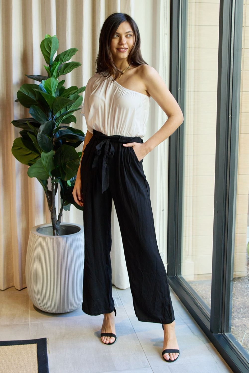 Manhattan One-Shoulder Jumpsuit in White/Black, featuring a chic one-shoulder design and a sleek monochrome color scheme, perfect for a sophisticated look.