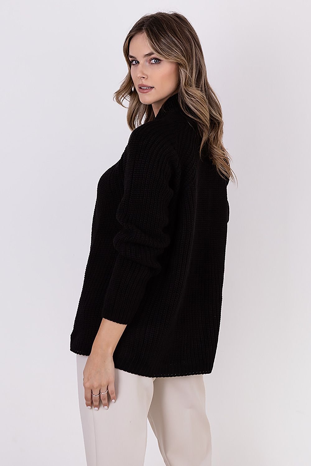  A ribbed cardigan featuring a standup collar showcasing a textured knit design in a neutral color.