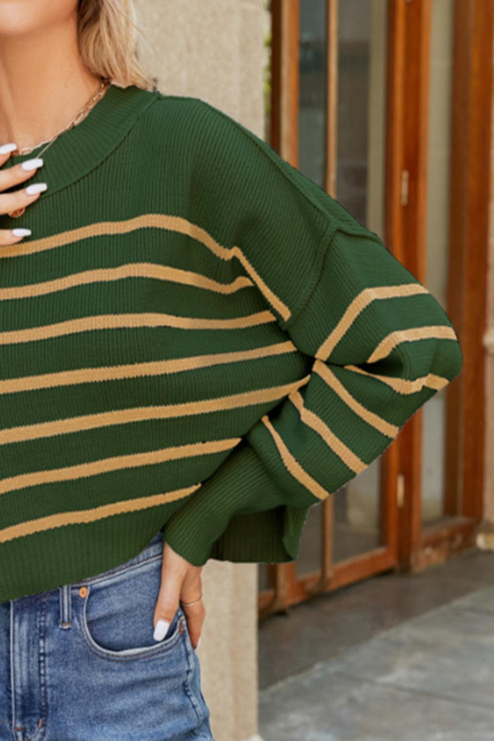  A round neck striped sweater featuring lantern sleeves showcasing a blend of vibrant colors and a cozy knit texture.