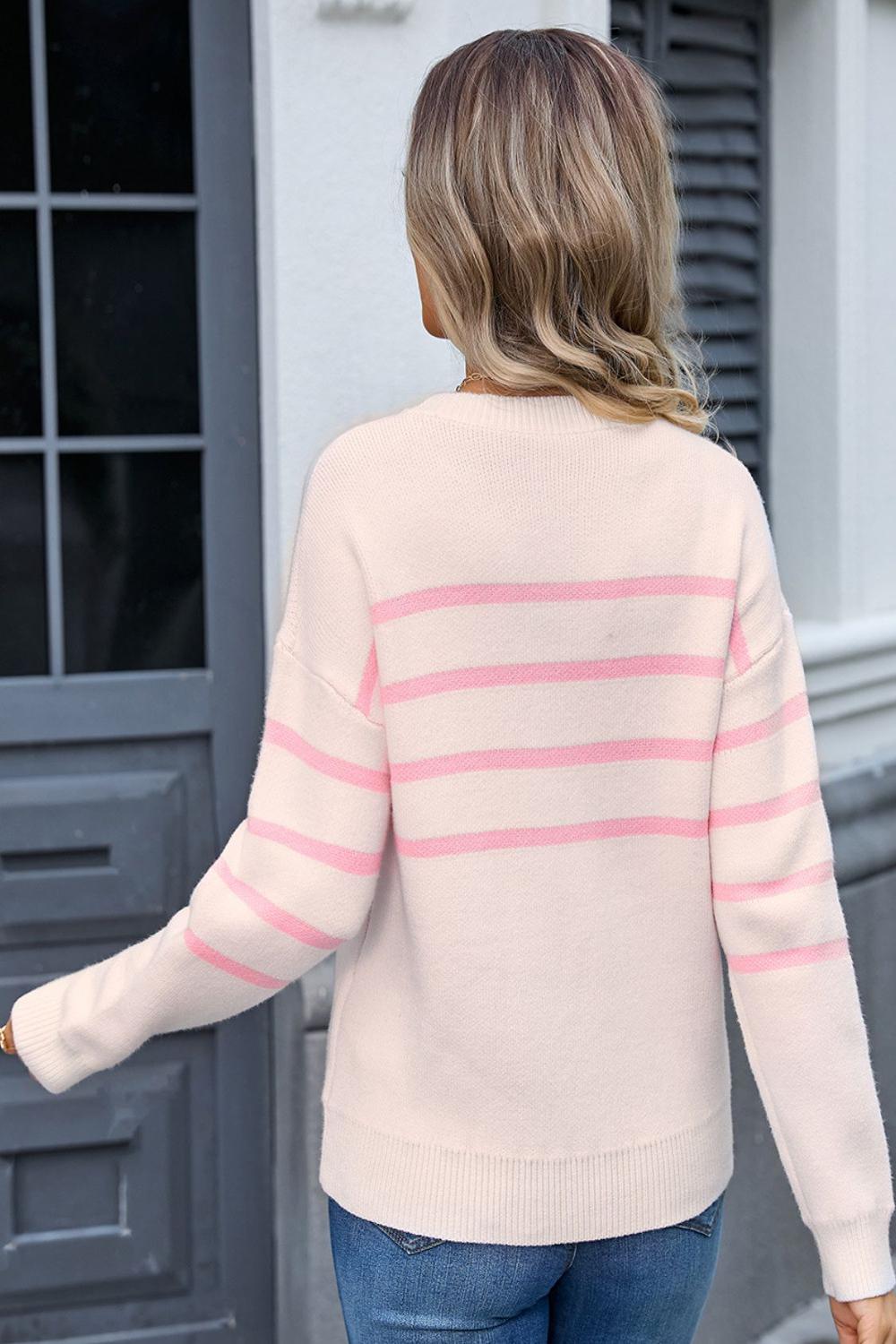 Striped round neck long sleeve sweater featuring a mix of bold colors with a relaxed fit and ribbed cuffs.