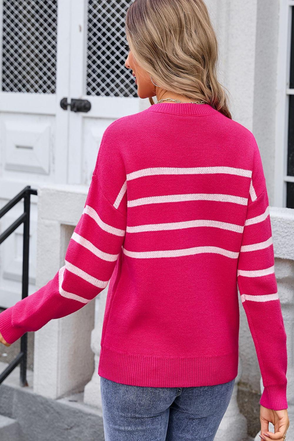 Striped round neck long sleeve sweater featuring a mix of bold colors with a relaxed fit and ribbed cuffs.