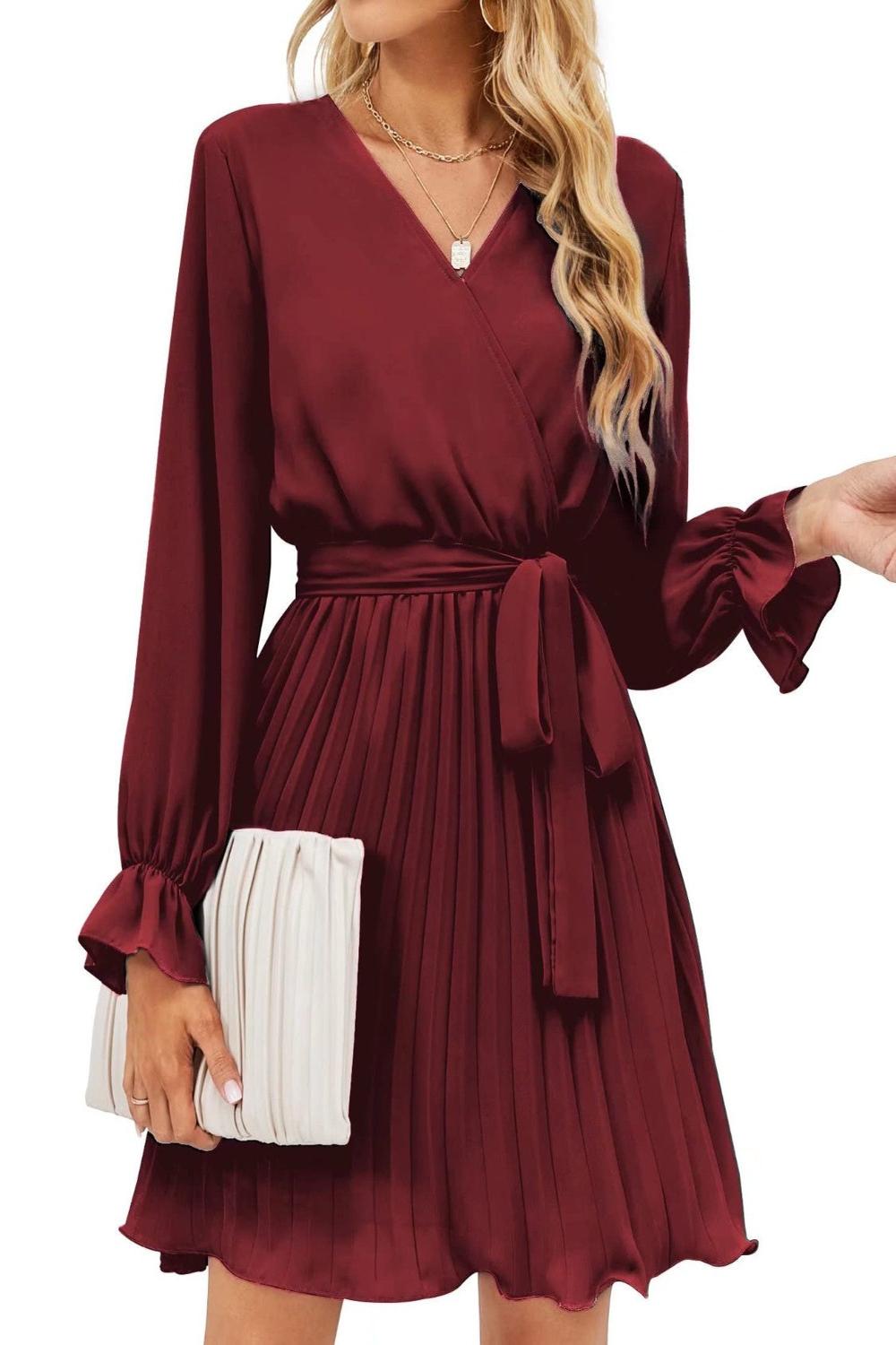  A stylish surplice flounce sleeve pleated mini dress in a vibrant color featuring a deep Vneckline flowing fl.