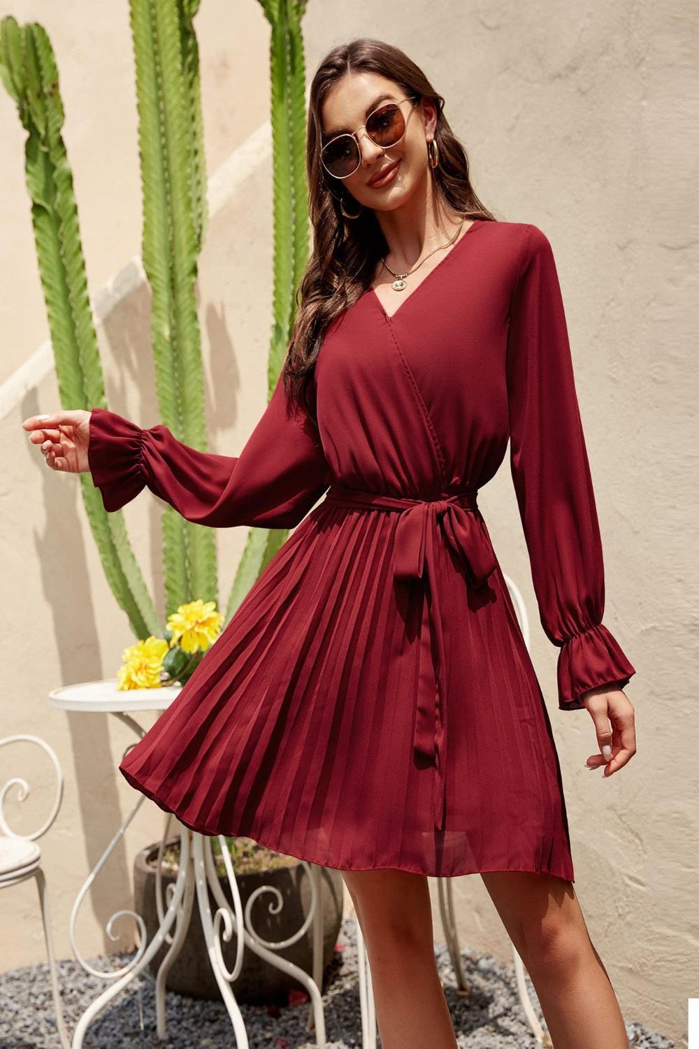  A stylish surplice flounce sleeve pleated mini dress in a vibrant color featuring a deep Vneckline flowing fl.