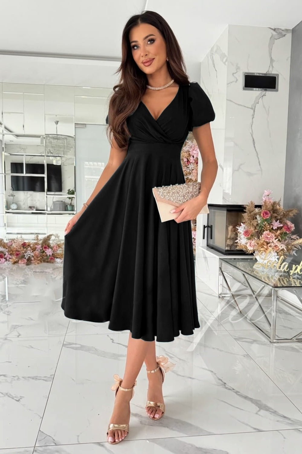 Elegant surplice midi dress featuring puff sleeves a fitted waist and a flowing skirt in a soft fabric perfect for a stylish occasion.