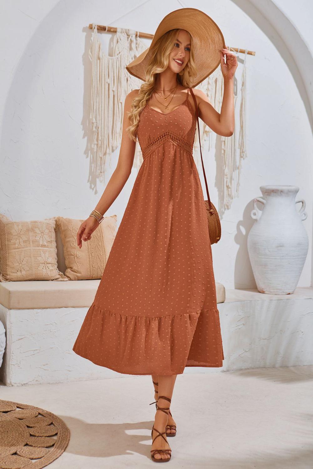 Elegant Swiss Dot VNeck Cami Dress featuring a lightweight textured fabric with delicate dot patterns adjustable spaghetti straps and a flowing silhouette.