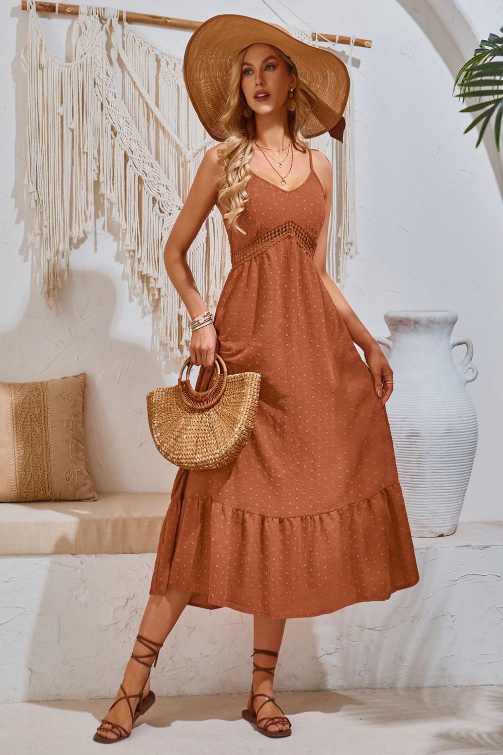 Elegant Swiss Dot VNeck Cami Dress featuring a lightweight textured fabric with delicate dot patterns adjustable spaghetti straps and a flowing silhouette.